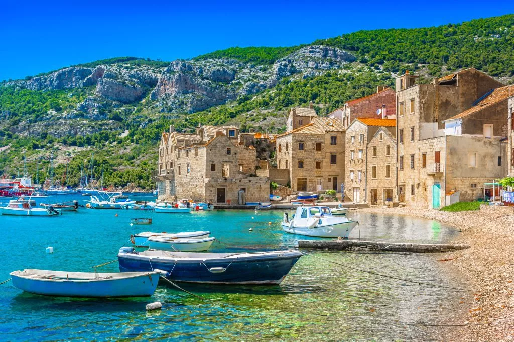 KOmiza seascape Island Vis. / Seafront scenic view at Komiza summer scenery in South of Croatia, mediterranean travel places.